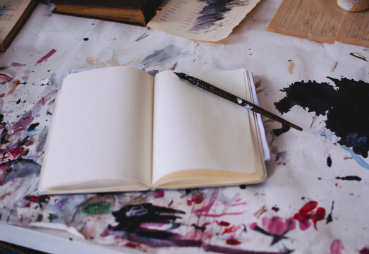 Blank book with pen in artist studio