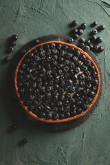Tray with blueberry pie on green background