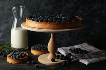 Concept of tasty lunch with blueberry pie on wooden background