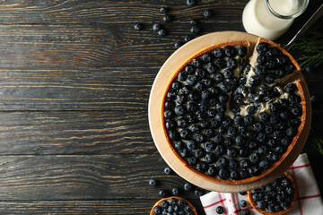 Concept of tasty lunch with blueberry pie on wooden background