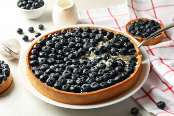 Concept of tasty lunch with blueberry pie on light background
