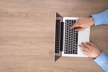 One hands typing on the computer keyboard