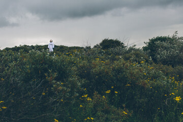 Person in spacesuit lost on earth.