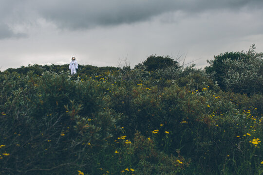 Person in spacesuit lost on earth.