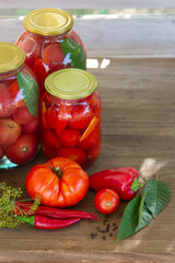 Preserves vegetables in glass on wood background, marinated fermented and pickled fermer food