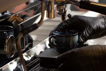 barista making coffee using a modern coffee machine.