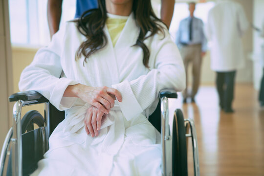 Hospital: Patient In Wheelchair Being Pushed By Nuse
