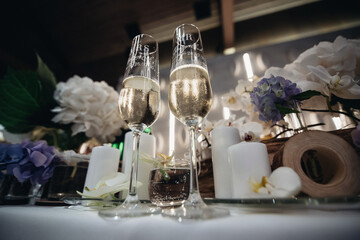 wedding glasses on the table between the decor, wedding glasses, glasses of champagne, 
 
