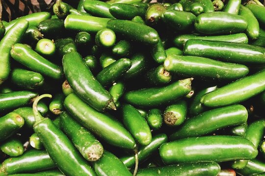 Fresh green jalepeno peppers for sale at a farmer's market