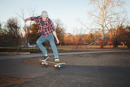 Skateboarder in mid-air while performing an ""ollie north""
