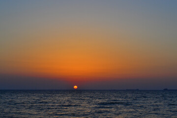 bright yellow circle of sun pink orange red dawn, sunset at sea, ocean, sky gradient, evening, morning
