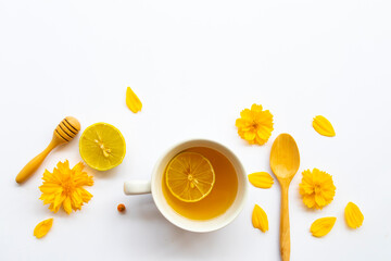 herbal healthy drinks hot honey lemon health care for cough sore with lemon slice ,yellow flowers cosmos of lifestyle arrangement flat lay style on background white 