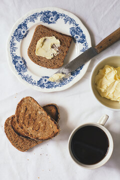Simple breakfast with toasts, butter and coffee