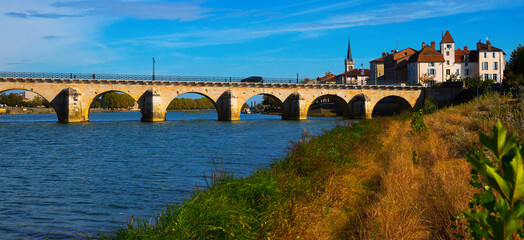 Fototapeta na wymiar Old arch Saint-Laurent bridge over river in Macon, France