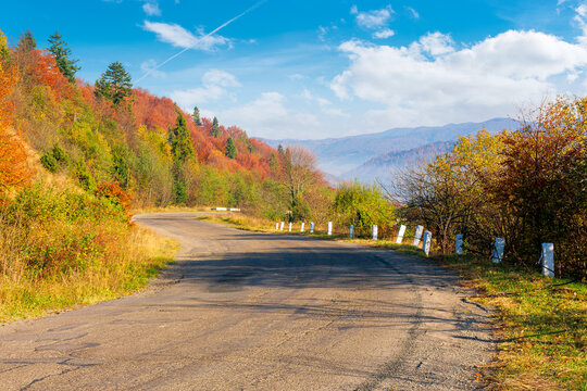 old serpentine road in mountains. beautiful autumn scenery on a sunny day. trees in colorful foliage. countryside journey on a weekend concept