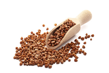 Buckwheat groats with a wooden spatula on a white background. image is isolated.