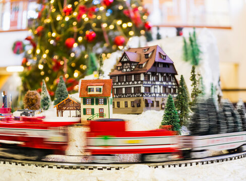 Toy train in motion and Christmas tree