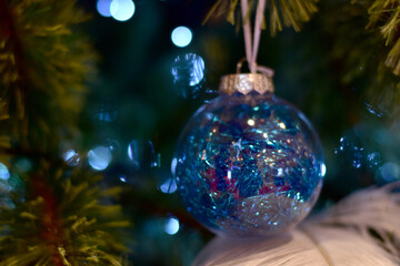 Closeup of Christmas Ball on Christmas Tree with bokeh beautiful background for design and decoration, new year concept, selective focus.