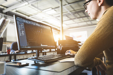 Engineer designer working on desktop computer in factory