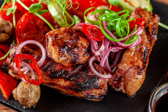 American cuisine. Fried pork ribs in josper. Serving food in a restaurant on a wooden board.