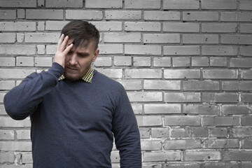 Man on the background of a wall of white bricks.