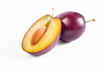 Plum half fruit close up macro shot. Oragnic sweet plums fresh and delicious. Fresh fruit snack. Isolated on white background.