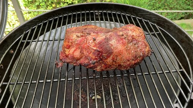 Liestal, Switzerland - September 22, 2020: A large piece of roast pork on the grill