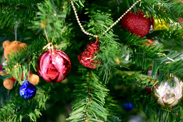 Closeup of Christmas Ball on Christmas Tree with bokeh beautiful background for design and decoration, new year concept, selective focus.