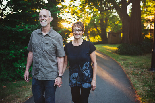 Middle aged, retired couple enjoying a walk together outside in nature