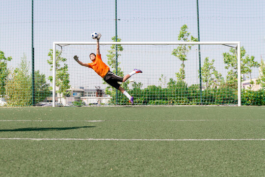 Goalkeeper stopping a ball during a soccer match