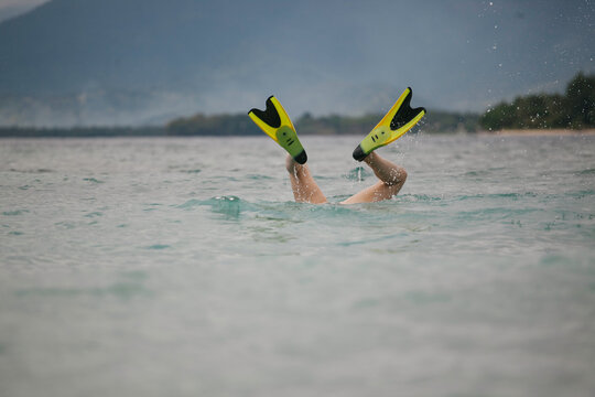 Diving under water with flippers on.