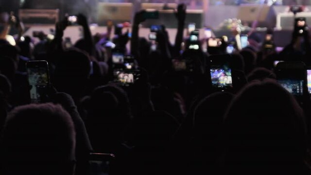 Silhouette of Crowd Making Video with Smartphone at Live Rock Concert. Slow Motion