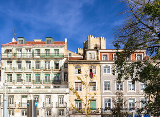 The colorful facade of old traditional residential buildings in the city downtown decored with ceramic tiles called Azulejos.Lisbon,Portugal