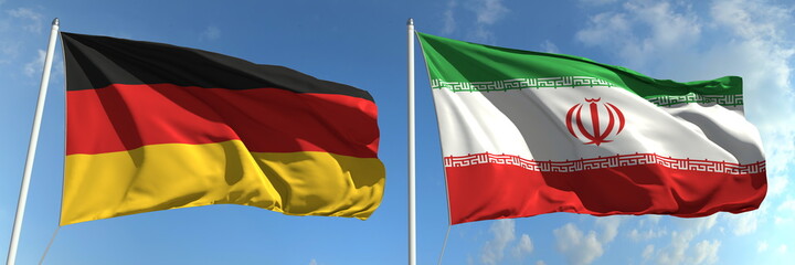 Flying flags of Germany and Iran on sky background, 3d rendering