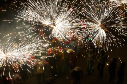 Spinning fire over a group of people