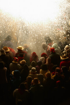 Multitude of people under a rain of sparks