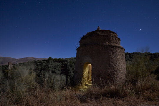 Night scene of the old Arab watchtower in the Fuente Camacho salt flats in Granada. Spain