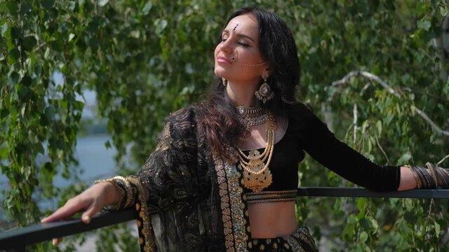 Portrait of a female model in ethnic indian costume with  jewellery and traditional makeup.  Woman in indian clothes dancing belly dance. Young beautiful woman in national costume dancing tribal dance