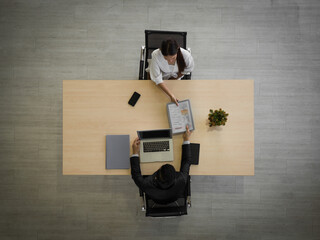 Asian candidate woman hand over her portfolio to the interviewer. Modern office job interview...