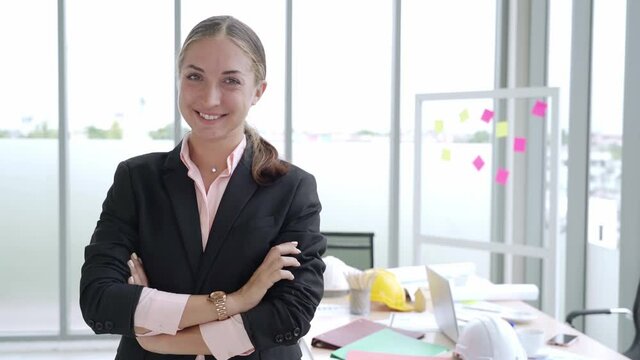 Portrait of cheerful and confidence businesswoman folded arm smiling in meeting room at office