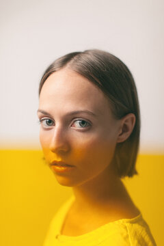 Portrait of a beautiful young woman with a yellow color effect.