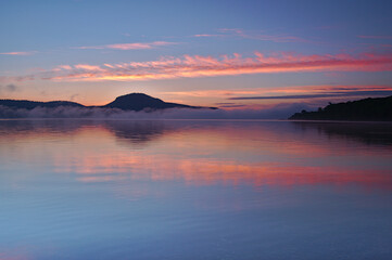 夜明けの空を映す朝の湖。屈斜路湖、北海道。