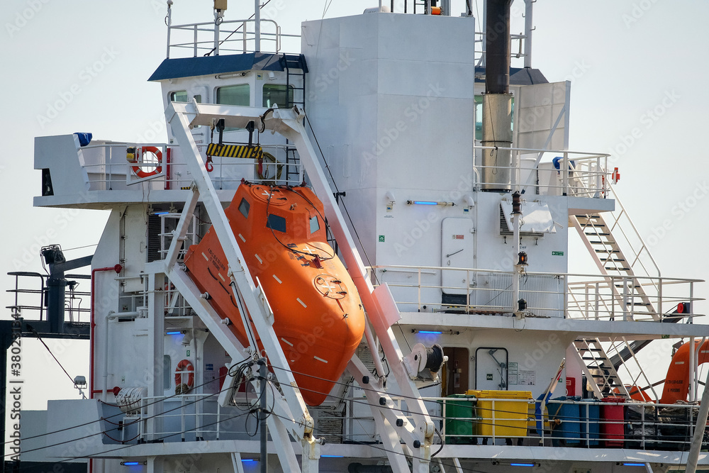 Wall mural orange lifeboat on a large ship