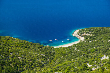 Croatia, amazing island of Cres on Adriatic coastline, aerial view of azure lagoon and beach under Lubenice town