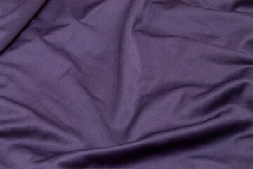 texture background uneven with folds T-shirt cotton and polyester fabric in dark blue