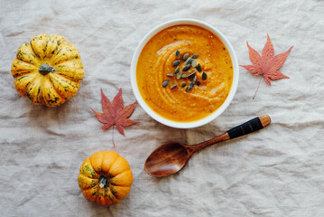 Hot pumpkin soup served with squash seeds in a bowl.