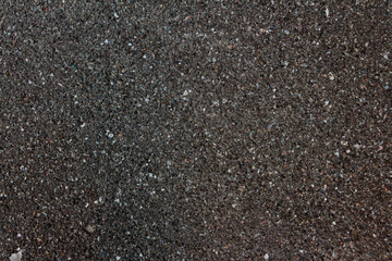 Dark gray asphalt concrete background. The texture of the asphalt road.
