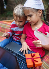 New normal online Christmas celebration. Kids celebrating with family via video chat