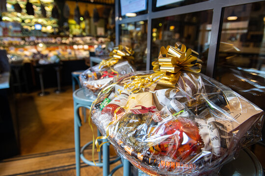 Big Christmas basket full of luxury food and drink delicatessen for sale in grocery store