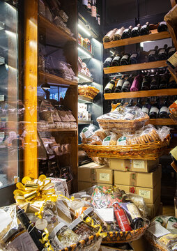 Christmas baskets full of luxury delicatessen in wine bar store bottles on shelf in background